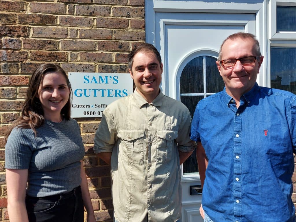Sam's Gutters team in front of office