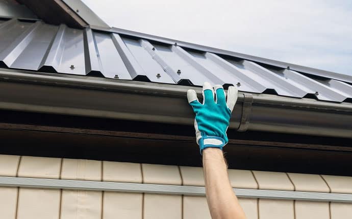 man replacing a gutter in Crystal Palace