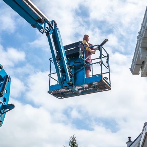 technicians on cherry picker for commercial gutter clean