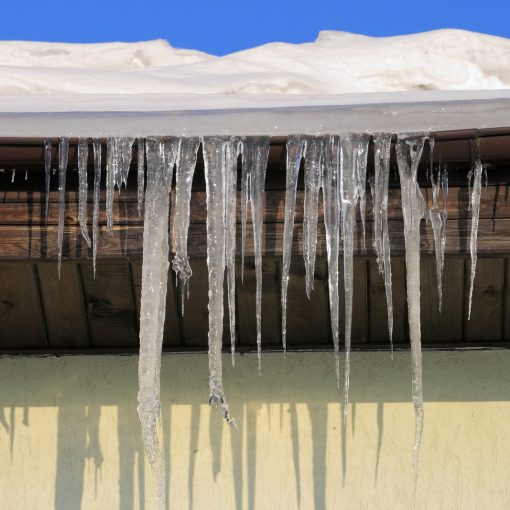 icicles hanging from gutters off roof